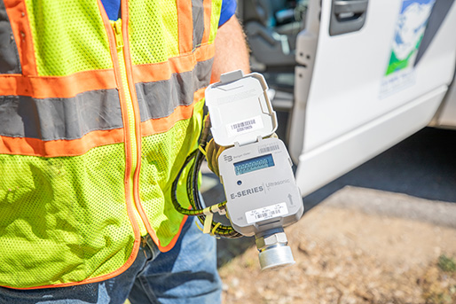 person holding water meter